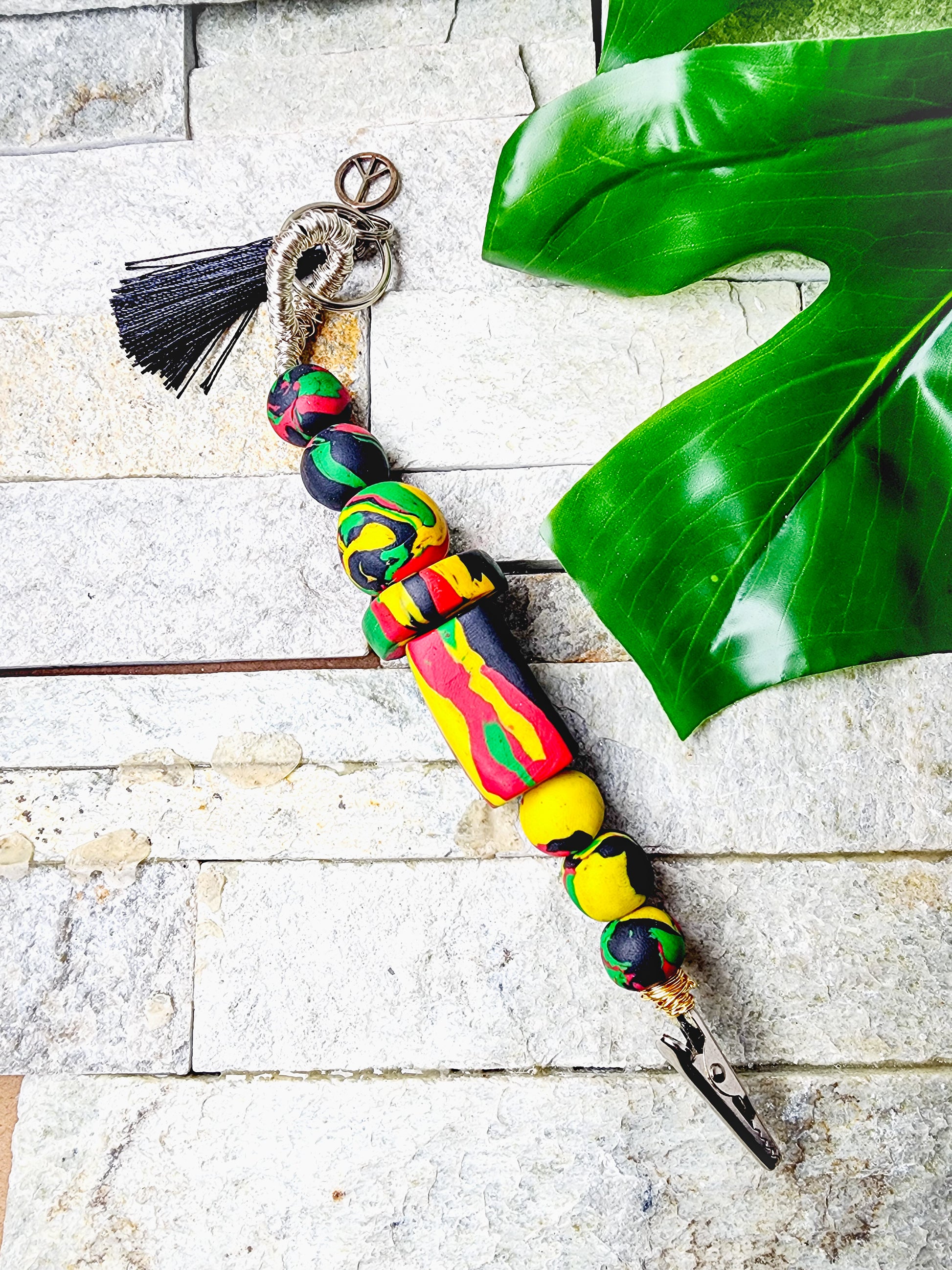 Statement card clip honoring Black heritage with vibrant clay beads