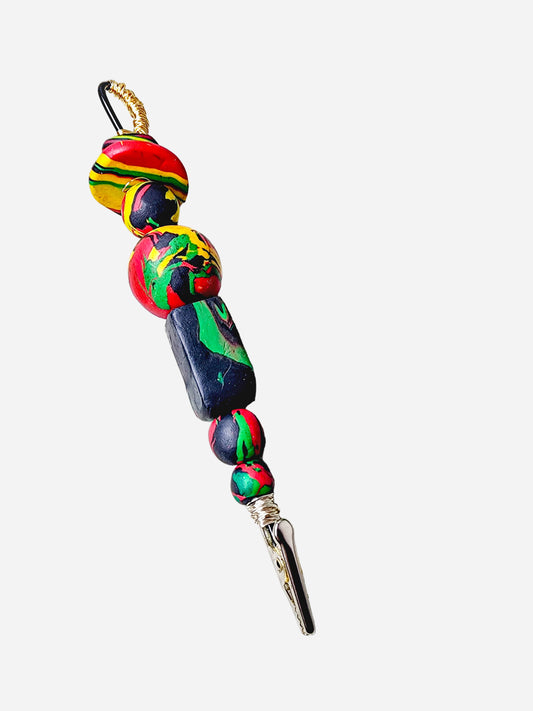Statement card clip honoring Black heritage with vibrant clay beads