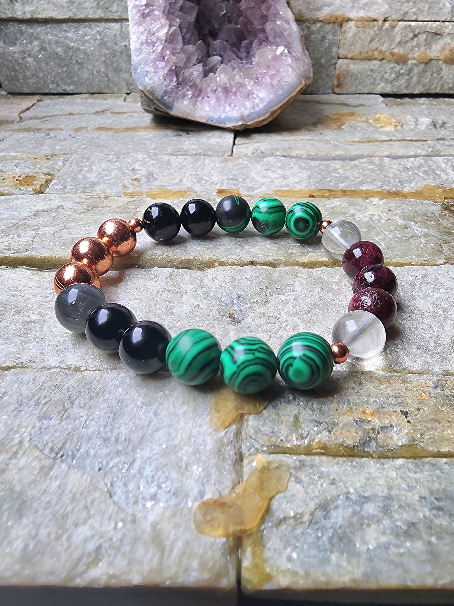 Ember Shield bracelet made with garnet, tourmaline, malachite, labradorite, and clear quartz worn on left wrist for grounding, protection, emotional strength, and energy defense