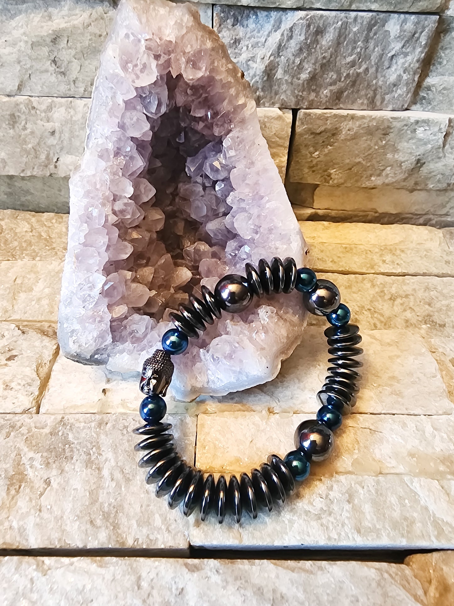 Enlightened Warrior bracelet featuring gunmetal hematite beads, blue hematite accents, and Buddha centerpiece for strength, balance, and spiritual protection