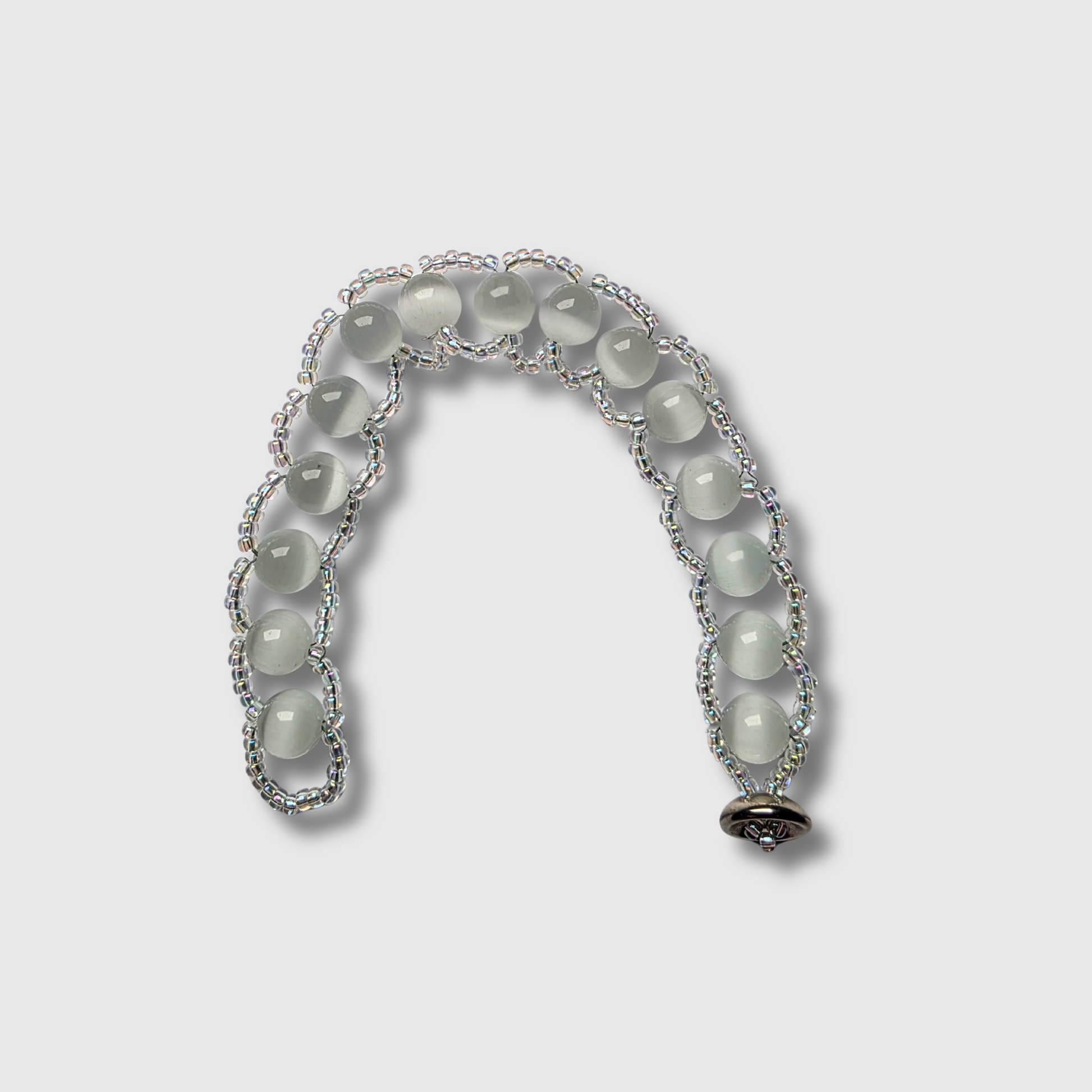 Cat’s Eye beaded bracelet sewn with needle and thread, featuring a cup button clasp and seed beads — handcrafted by JvOR