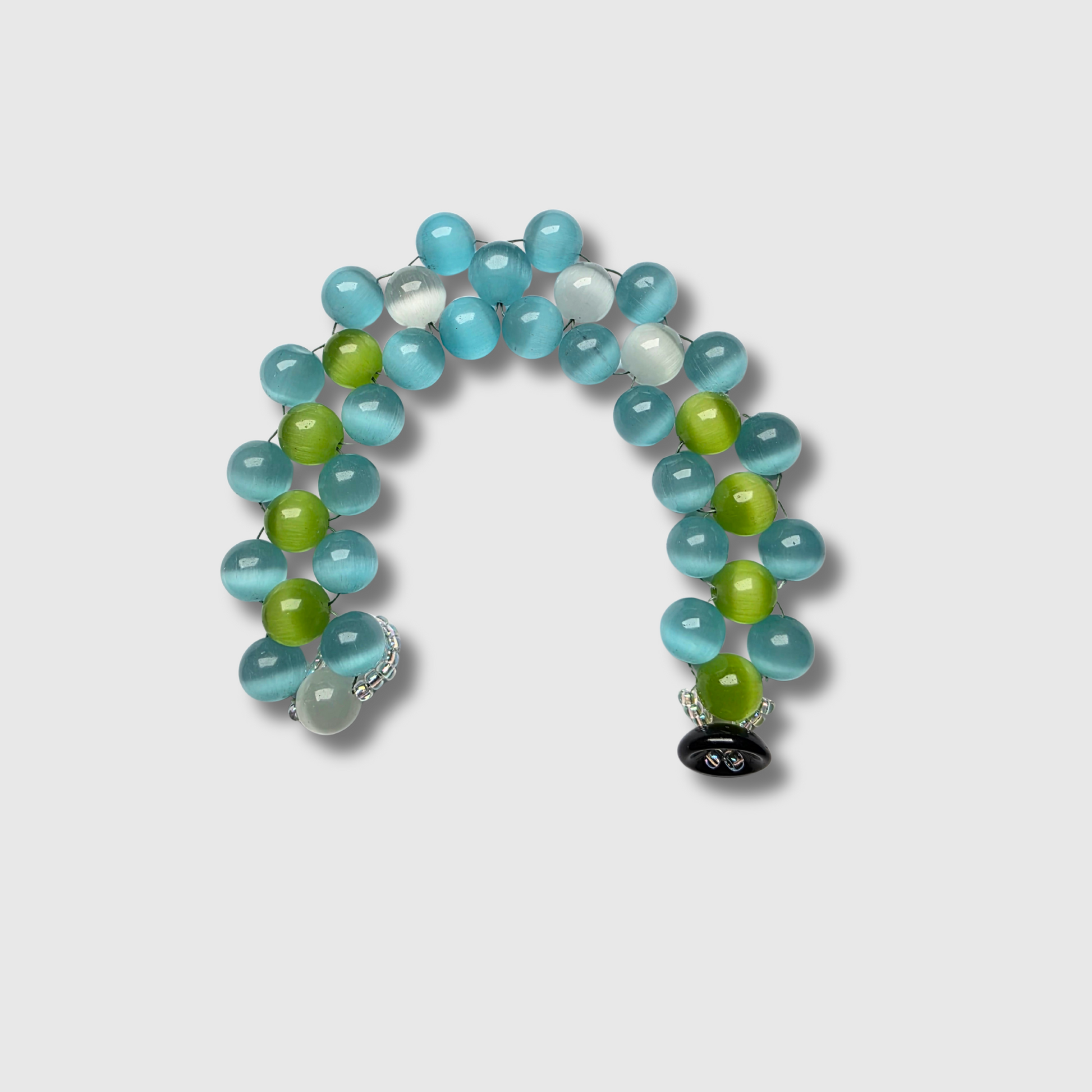 Cat’s Eye beaded bracelet sewn with needle and thread, featuring a cup button clasp and seed beads — handcrafted by JvOR