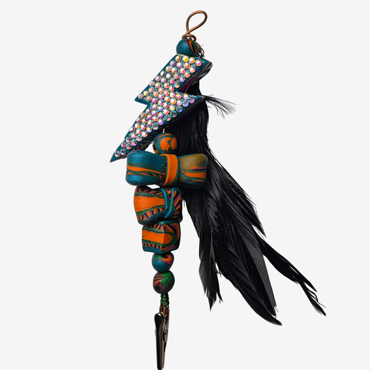 Colorful polymer clay card clips with bold patterns, spikes, roses, feathers, and sculpted designs — wearable mini artworks that fuse art, originality, and utility