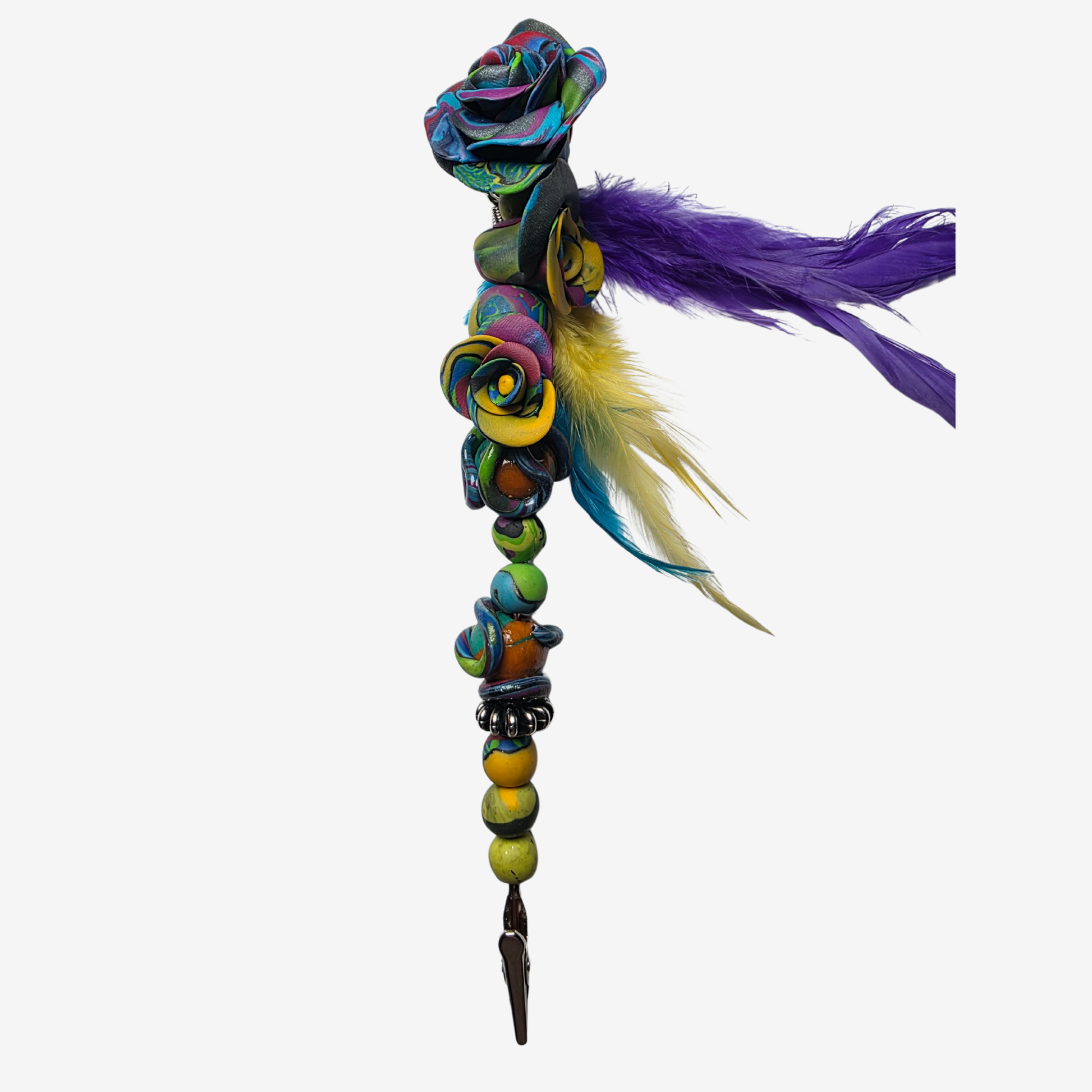 Colorful polymer clay card clips with bold patterns, spikes, roses, feathers, and sculpted designs — wearable mini artworks that fuse art, originality, and utility