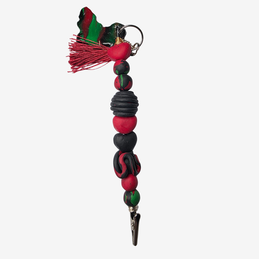 Handmade polymer clay card clips in Pan-African red, green, and black with bold textures and unique designs — functional accessories that celebrate culture and creativity