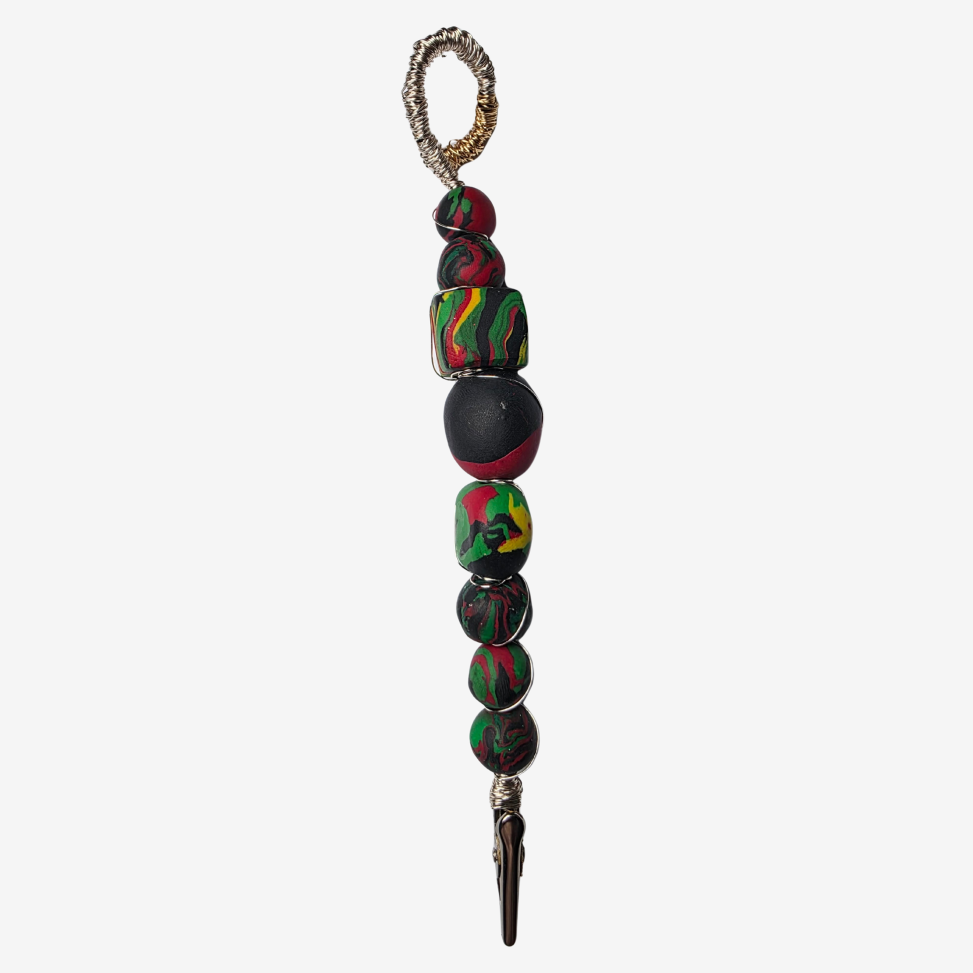 Handmade polymer clay card clips in Pan-African red, green, and black with bold textures and unique designs — functional accessories that celebrate culture and creativity.