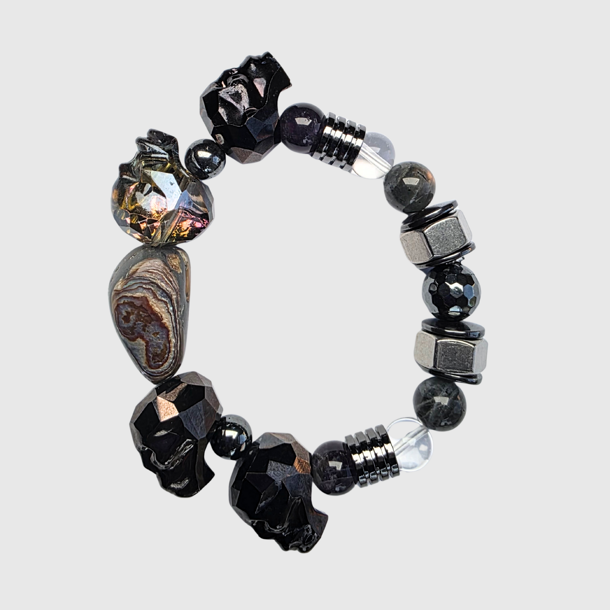Black crystal bracelet with labradorite, hematite, abalone, amethyst, clear quartz, gunmetal skulls, and hex nut accents – bold statement jewelry
