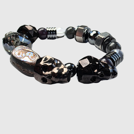 Black crystal bracelet with labradorite, hematite, abalone, amethyst, clear quartz, gunmetal skulls, and hex nut accents – bold statement jewelry