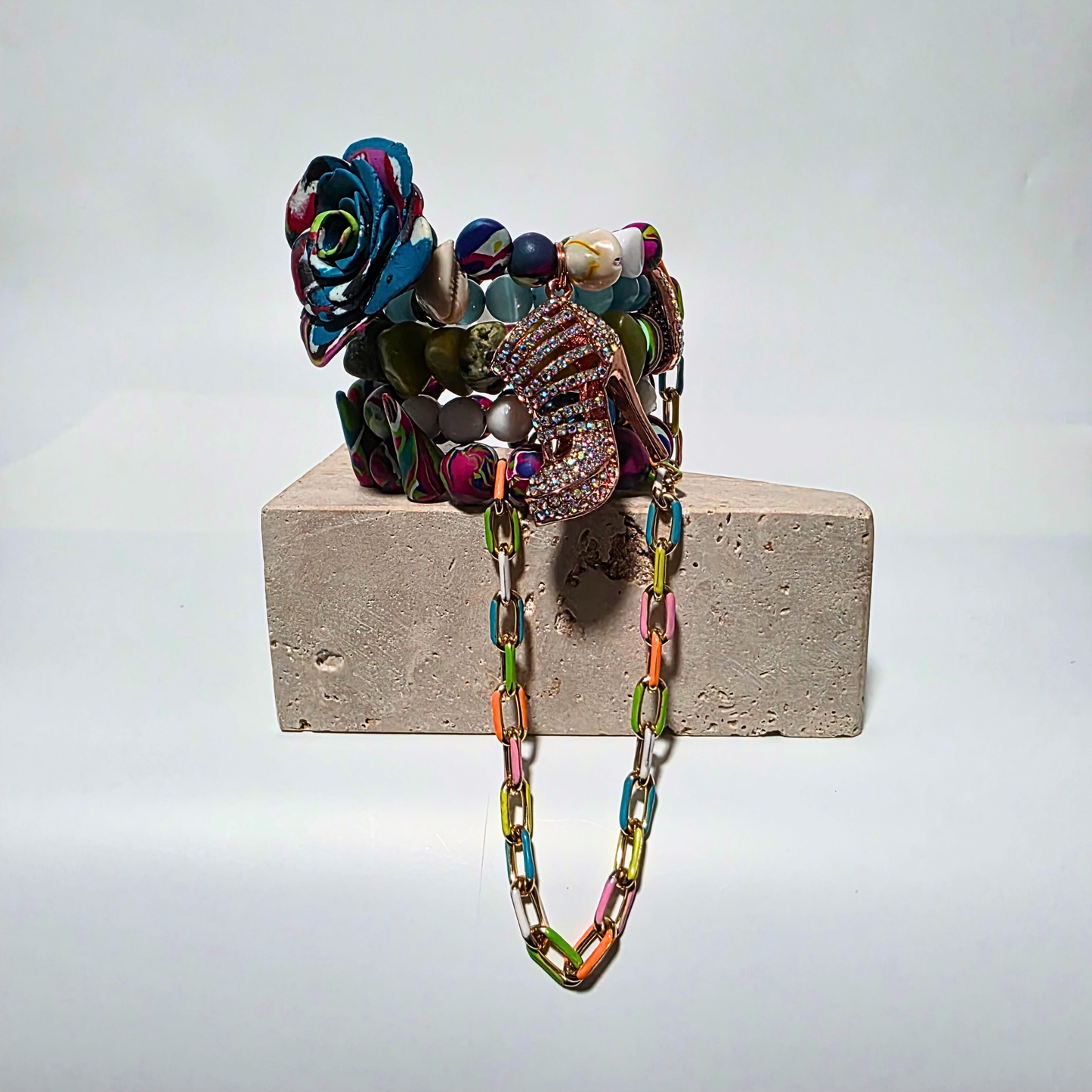 Colorful 5-loop artisanal bracelet featuring crystals, handmade clay beads, and gunmetal chain accent.