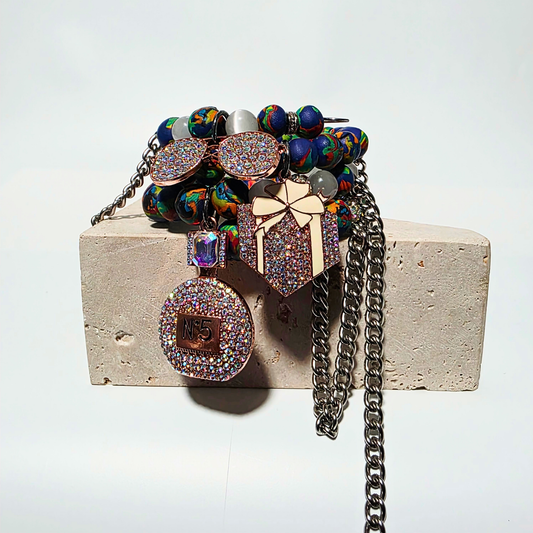 Ivory Riot bracelet — white cat’s eye crystals, handmade clay beads, sterling-silver chains, three rhinestone charms, multi-layer wrapped bracelet by JvOR.