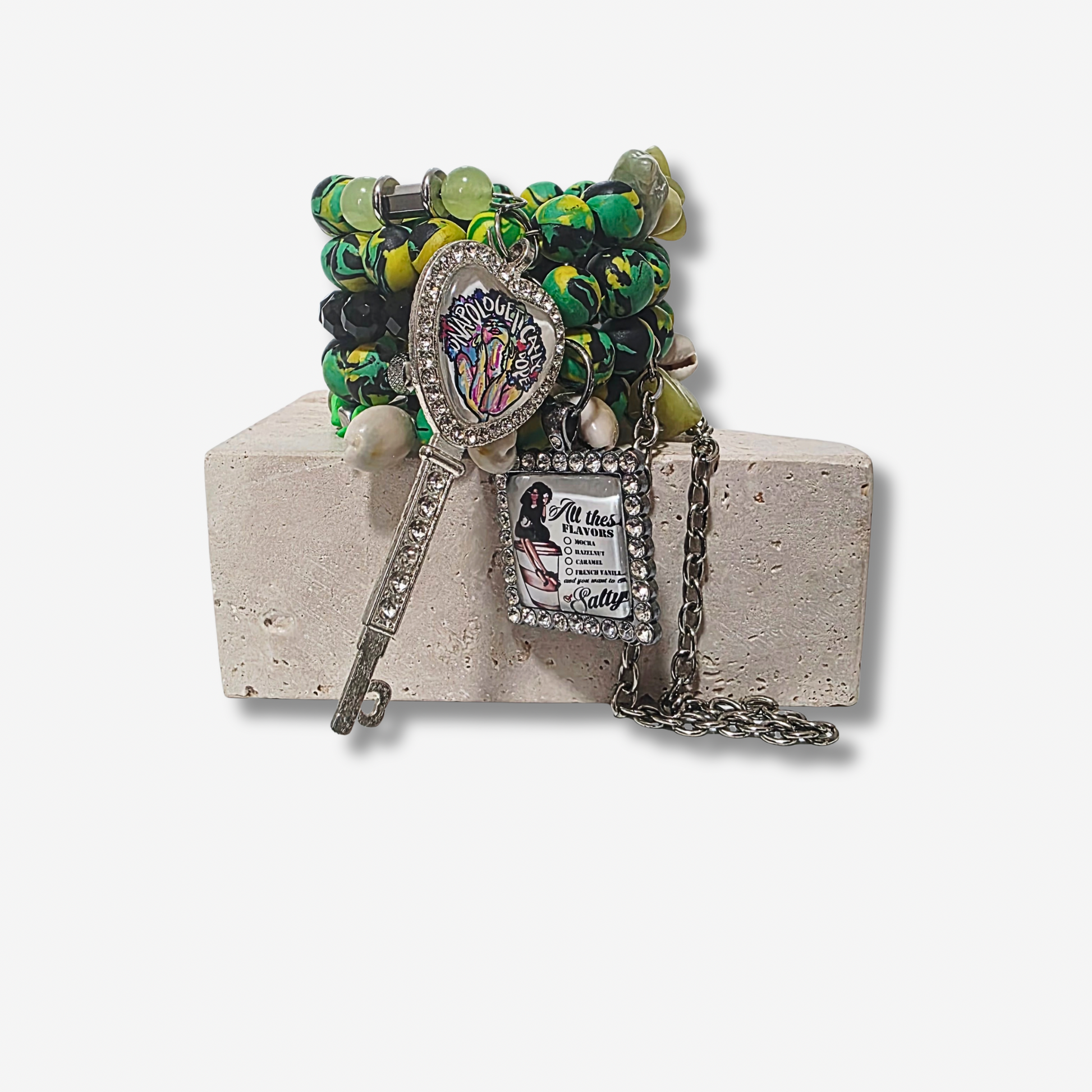 Jamaican Sirenblade bracelet with Jamaican-inspired polymer clay beads, black agate crystals, cowrie shells, rhinestone charms, and gunmetal chains.