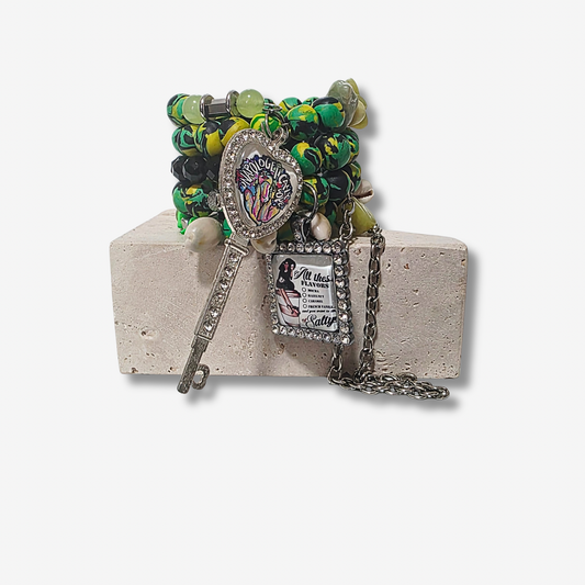 Jamaican Sirenblade bracelet with Jamaican-inspired polymer clay beads, black agate crystals, cowrie shells, rhinestone charms, and gunmetal chains.