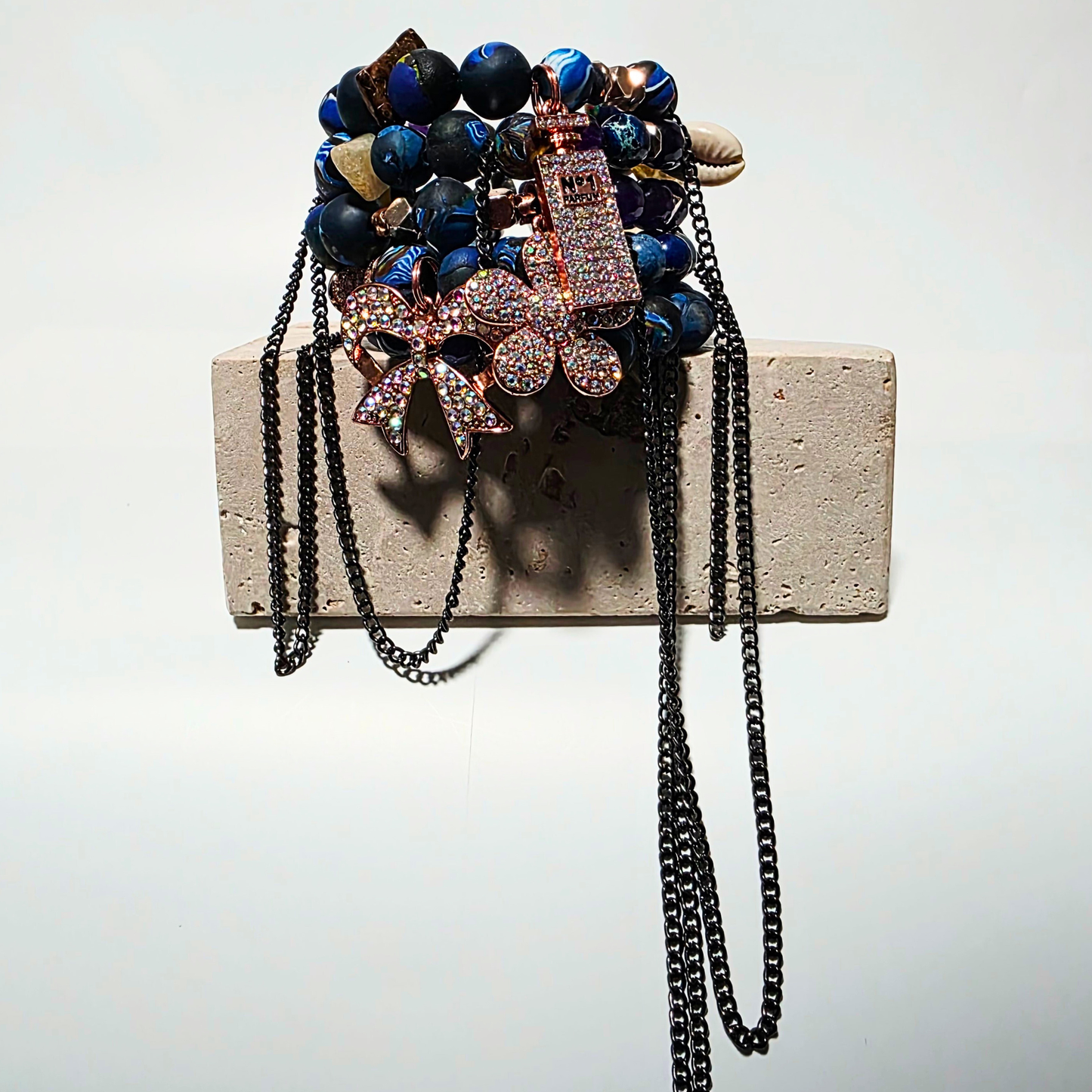 Ivory Riot bracelet — white cat’s eye crystals, handmade clay beads, sterling-silver chains, three rhinestone charms, multi-layer wrapped bracelet by JvOR.