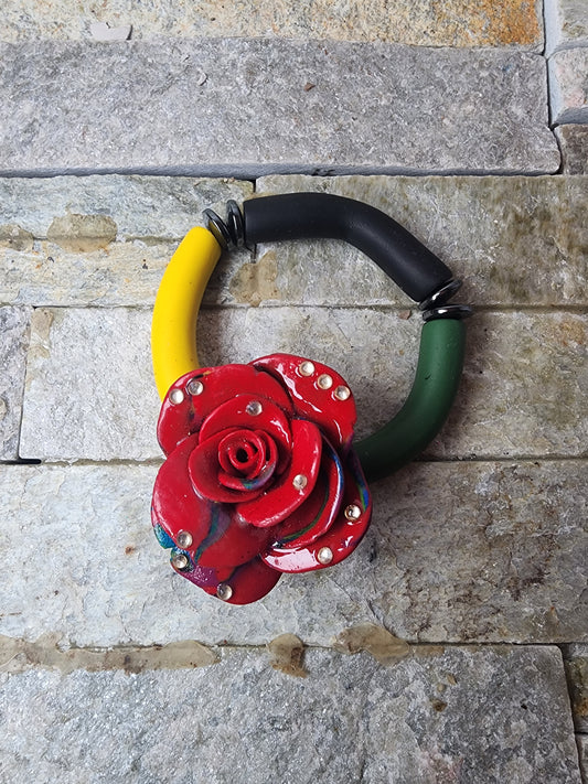 JOUNEY BRACELET WITH PAN-AFRICAN POLYMER CLAY BEADS AND A RED CLAY ROSE - SYMBOL OF TRANSFORMATION, STRENGTH, AND BEAUTY.