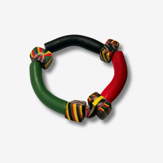 Handmade Pan-African polymer clay bracelet in red, black, and green beads, with copper coils and charms for women.