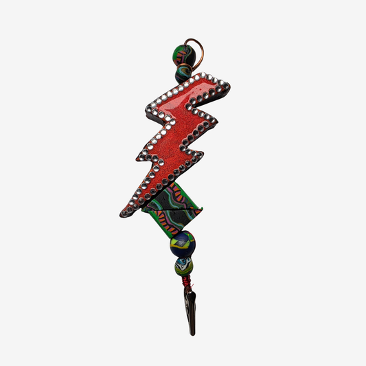Colorful polymer clay card clips with bold patterns, spikes, roses, feathers, and sculpted designs — wearable mini artworks that fuse art, originality, and utility