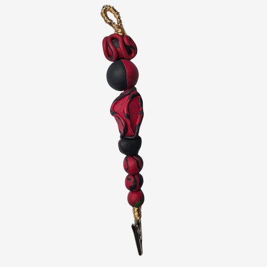 Handmade polymer clay card clips in Pan-African red, green, and black with bold textures and unique designs — functional accessories that celebrate culture and creativity