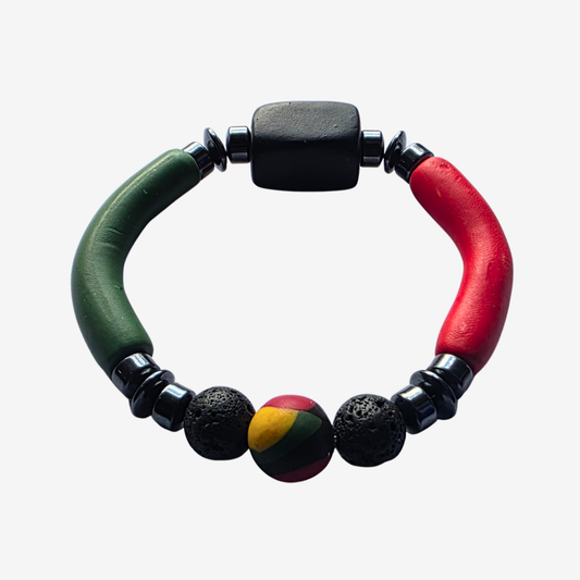 Handmade men’s bracelet with polymer clay beads in Pan-African colors of red, green, and black, combined with grounding lava stone and protective hematite crystal beads — bold statement design from JvOR’s MANCAVE collection