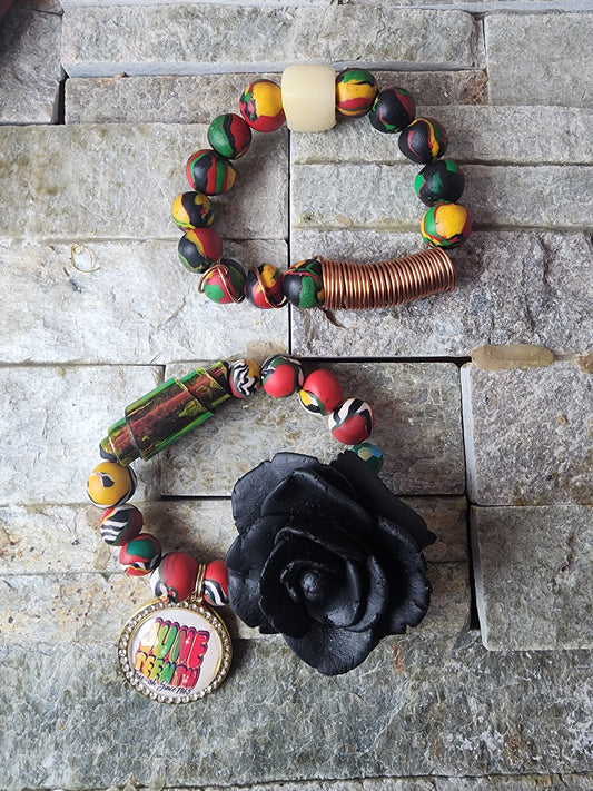 Rukiya is a bold celebration of heritage, strength, and sacred femininity. Handcrafted using vibrant Pan-African colors — red, black, green, and gold — this polymer clay bracelet features a radiant copper focal bead and a sculpted black rose centerpiece, symbolizing resilience and transformation. Each bead is intentionally crafted to honor ancestral pride while radiating personal power. Rukiya is more than jewelry — it’s a tribute to where you come from and who you’re becoming.