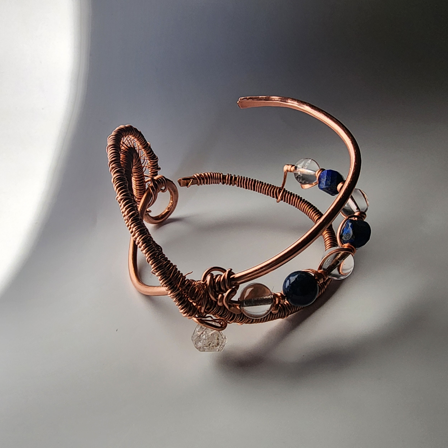 adjustable copper cuff bracelet with herkimer diamond clear quartz and lapis lazuli infinity symbol structure
