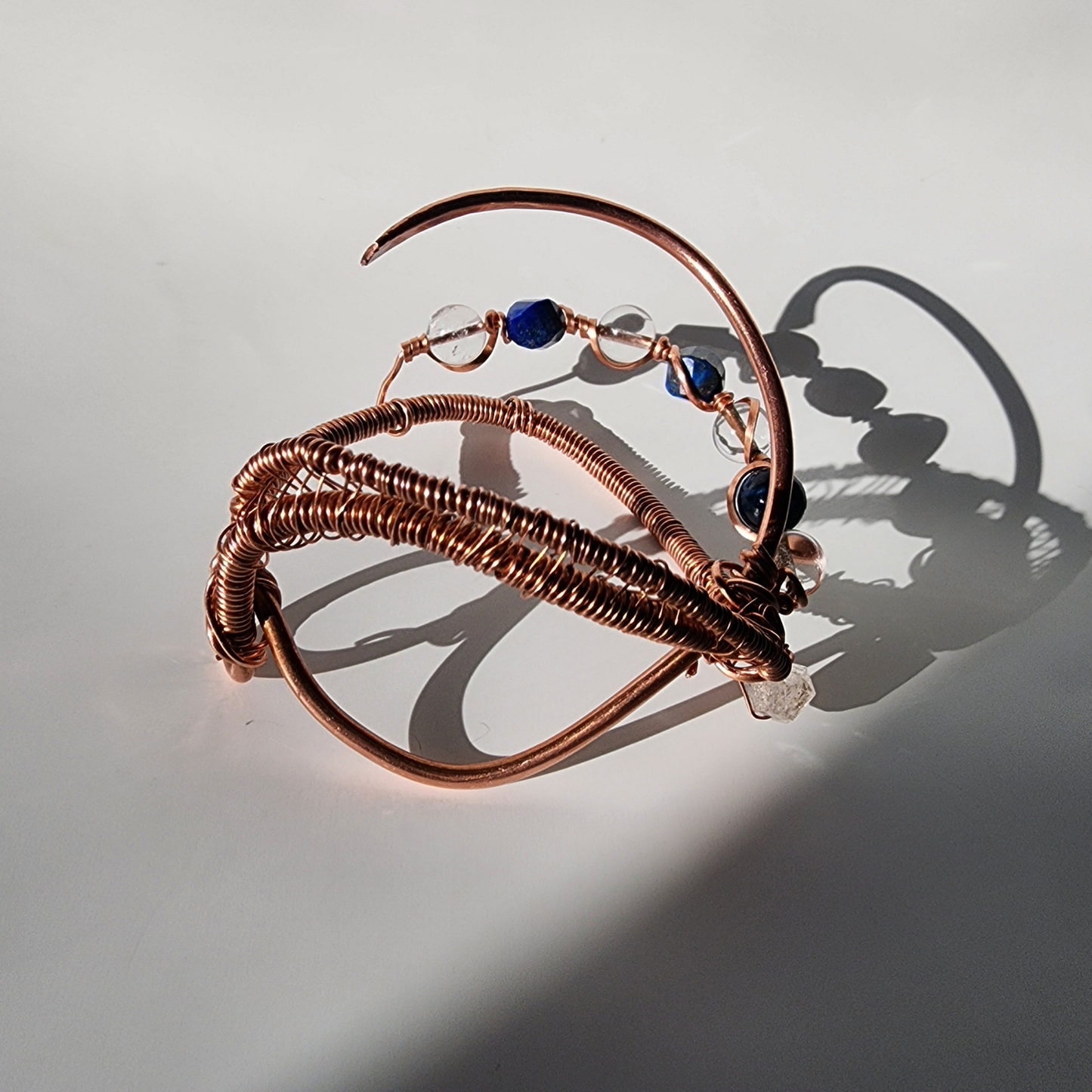 wire wrapped copper cuff bracelet craftsmanship detail with herkimer diamond clear quartz and lapis lazuli

